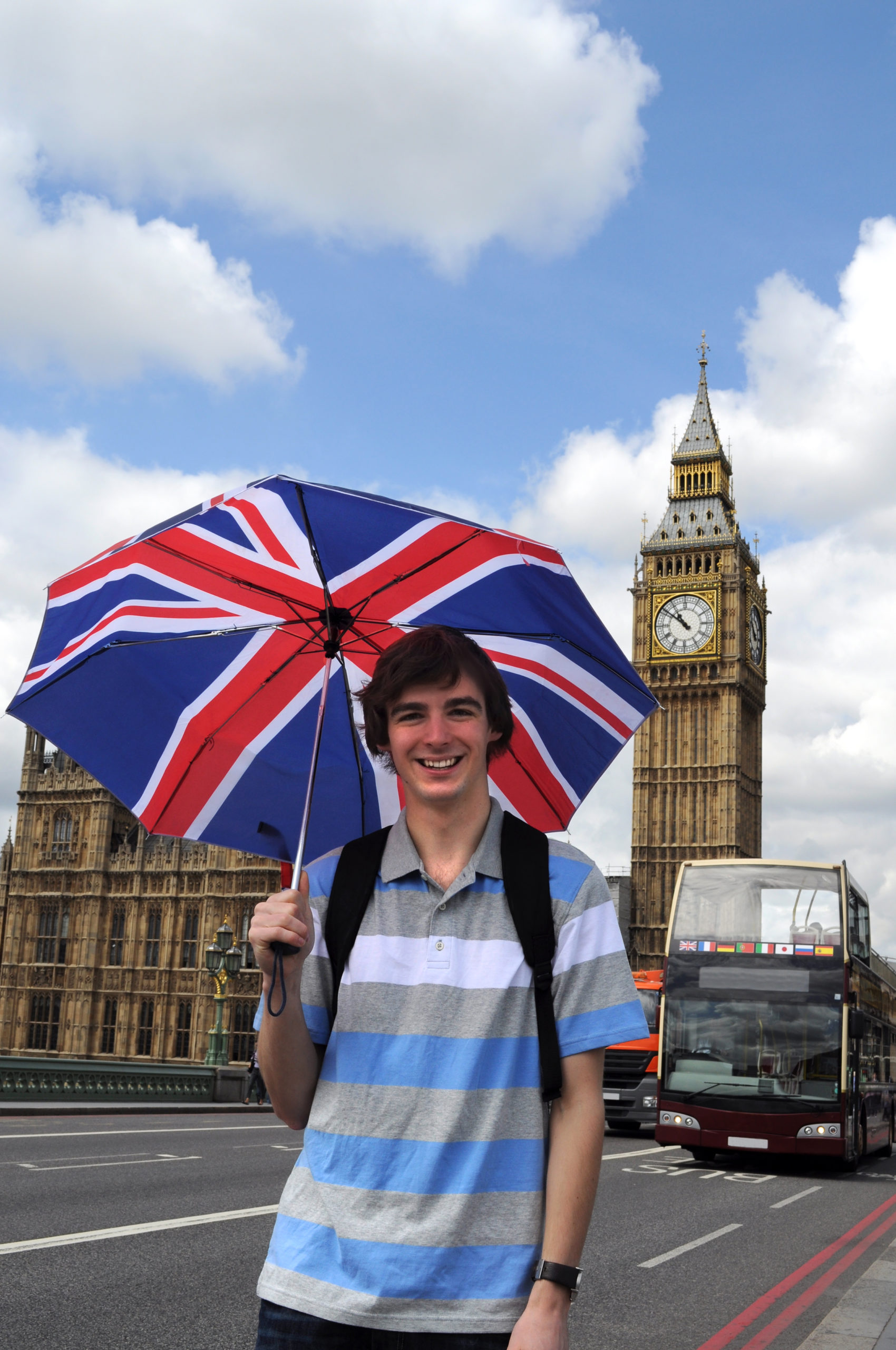 Big Ben and tourist with British flag umbrella at Westminster bridge in London